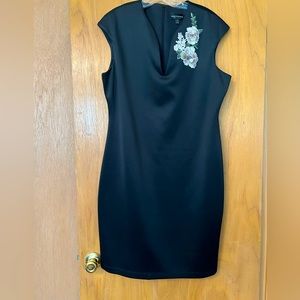 Black sleeveless knee length fitted dress with embroidered flowers
